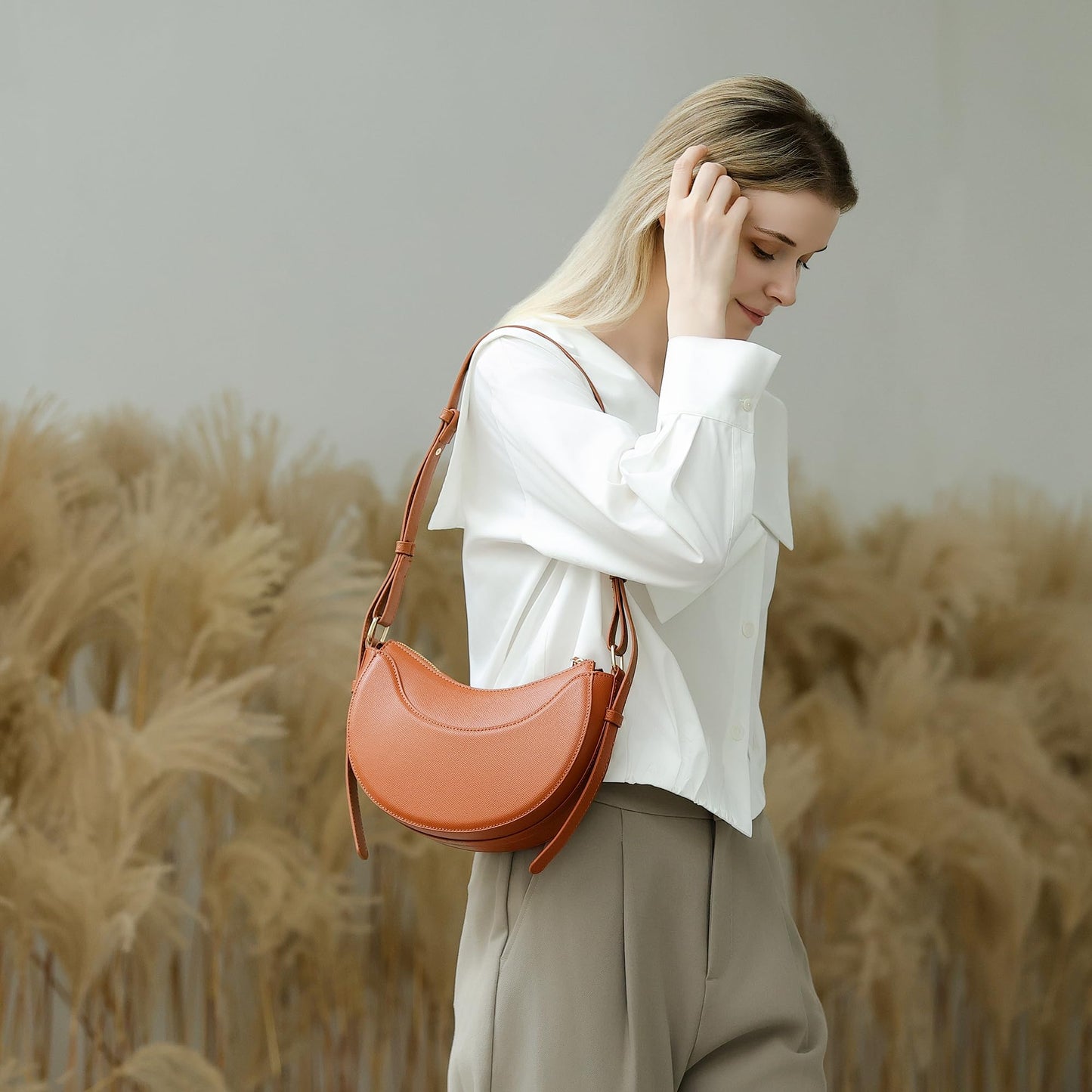 Herald Small Leather Crossbody Bag for Women, Designer Crescent Shoulder Purse Handbag with Adjustable Strap & Tassel (Brown)